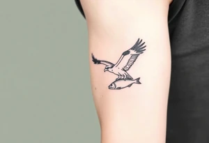 Osprey in flight with fish grasped between its talons tattoo idea