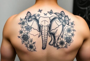 Elephant tattoo surrounded by flowers and butterflies with Chinese lettering tattoo idea