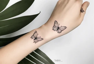 a long unique small feminine leaftattoo with two butterflies on the wrist tattoo idea