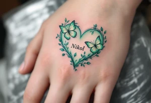A pastel green heart with butterflies and Nikol written in elegant lowercase. tattoo idea