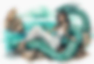 A sea serpent with the head of a woman covered in turquois scales sitting on rocks by the ocean tattoo idea