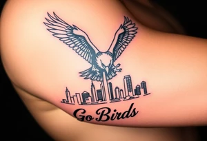 Philadelphia Eagle flying toward front over Philadelphia city skyline faded with a Go Birds written under it tattoo idea