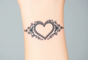 A heart-shaped lace pattern bracelet in black and silver, with a delicate filigree border tattoo idea