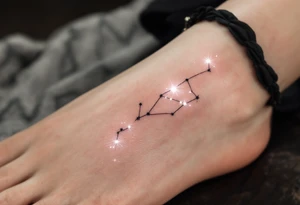 A tiny constellation in white glows from inside a black-ink outline of scales on the ankle. tattoo idea