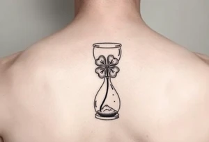 4 leaf clover growing in a hourglass tattoo idea