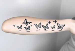 Six different butterflies streaming down arm with six kids names Aden, Aninna, Novaih, Rayla, Jayla, Teresa tattoo idea