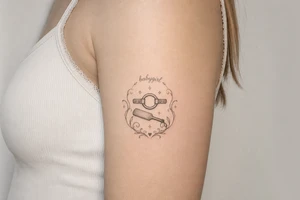 A tattoo for a submissive named babygirl, with a ring gag and a paddle. tattoo idea