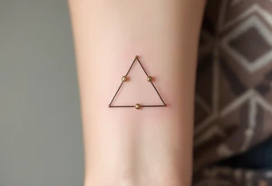Three gold ink dots placed behind the ear in a triangle, inspired by celestial navigation and guidance. tattoo idea