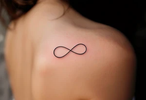 A geometric infinity loop with thin black lines and a tiny magenta heart hidden in the corner. tattoo idea
