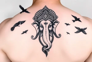 black and white Ganesha head tattoo with crows fly towards and away from him tattoo idea