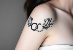 two wedding rings combined with angel wings tattoo idea