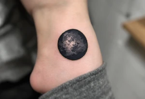A solid black circle with a thin gold outline, evoking elegance and strength. tattoo idea