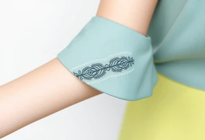 A lace-trimmed ribbon around the forearm, with fine embroidery-inspired details tattoo idea
