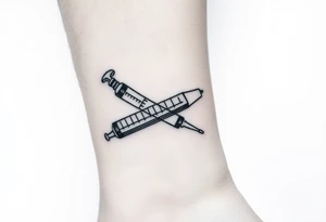 nurse syringe crossing like crossbones tattoo idea