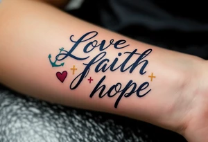 Script in deep navy ink, with a heart in burgundy, a gold cross, and a teal anchor subtly integrated into the words love faith hope. tattoo idea