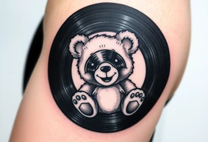 minimalist teddy bear with vinyl records as eyes smiling and sitting on a record tattoo idea