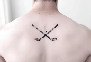 Ella with hockey sticks for L tattoo idea