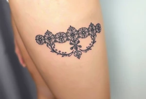 A negative space garter tattoo design, where the lace details are subtly left out tattoo idea