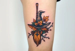 Which is broom with handle
 a witches hat with fall maple leaves, feathers and vines tattoo idea
