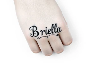 "Briella" in old English style on hand along thumb tattoo idea
