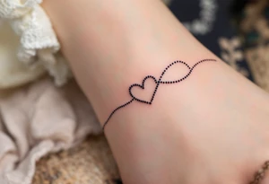 A fine-line black infinity band with a delicate heart in the shape of a fingerprint in maroon. tattoo idea