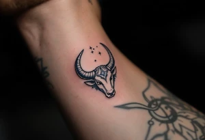 In the indigo sky, the silver horns of Taurus reach toward its star constellation with earthy determination. tattoo idea