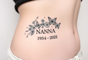 flowers and butterflies with the name “NANA” and the date “1954-2022” mixed all together on the side of the rib cage tattoo idea