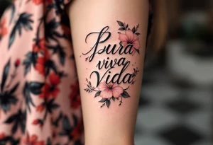 "Pura Vida” in elegant black script wrapped with tropical hibiscus flowers in shades of pink and coral. tattoo idea