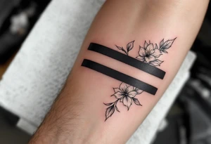 2 black bands with roman numerals across them in negative, between the black bands are full of narcissus flowers and holly tattoo idea