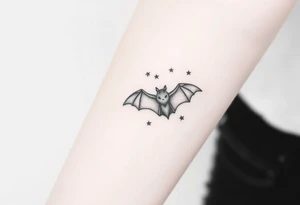Small bat flying in front of stars tattoo idea