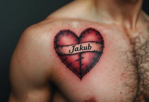 A tattoo of a stitched heart in crimson with Jakub written across the seam. tattoo idea