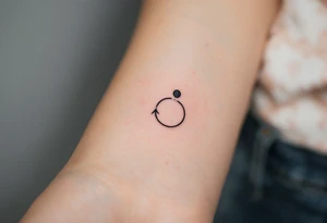 A comma with a dot above it, with an arrow around tattoo idea