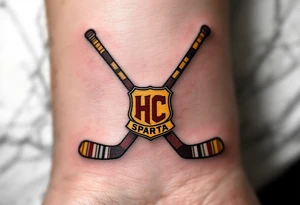 Two crossed hockey sticks with the HC Sparta crest in deep red and yellow centered on the wrist. tattoo idea