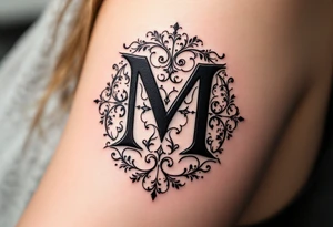 A bold blackletter-style "M" in deep onyx black with sharp gothic edges. tattoo idea