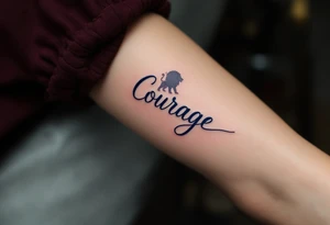 “Courage” in bold navy blue, paired with a simple lion silhouette in soft gray. tattoo idea