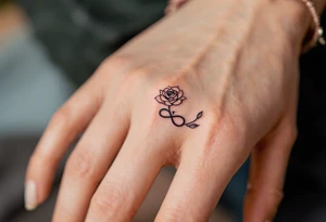 A rose band on finger with a small infinity symbol tattoo idea