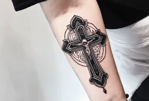 a forearm tattoo with cross and rosary around it tattoo idea