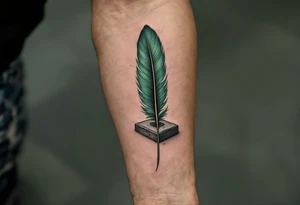 A deep green feather of Ma’at, symbolizing truth and balance, resting on a gray stone tablet. tattoo idea
