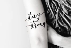 “Stay strong” in bold black script wrapped with a dark red heartbeat line. tattoo idea