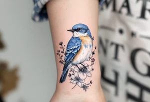 Puffy bluebird surrounded by wild flowers tattoo idea