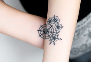 Compass with cursive letters with flowers flowing above and below tattoo idea