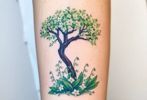 Lilly of the vally bell plants on the ground underneath a majestic blooming hawthorn tree tattoo idea