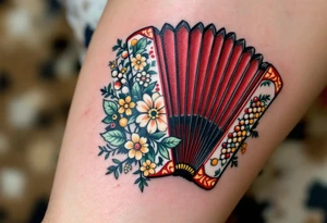 Accordion with Folk Motifs – A red and black accordion decorated with ornate folk-style floral patterns in greens and yellows, representing joy, tradition, and dancing spirit. tattoo idea