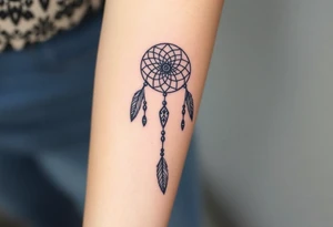 native dreamcatcher with flowing feathers and sacred beads tattoo idea