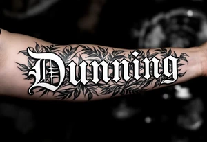 Dunning, left forearm details include angel wing, greek type of font,jungle leaves, name is big and in white color tattoo idea