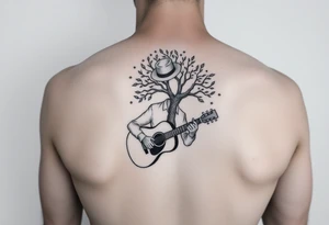 Man with hat but cant see face 
playing acoustic guitar underneath tree of life concept style tattoo idea