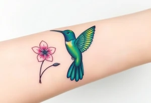 A hummingbird in iridescent green and blue shades, hovering near a blossoming flower, embodying endurance and positivity tattoo idea