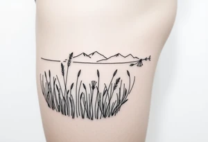 A field with long grass and flowers with mountains in the background tattoo idea