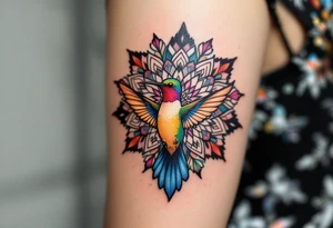 Colorful hummingbird centered in front of a mandala design tattoo idea