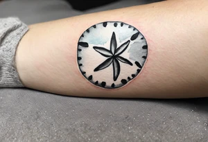 sand dollar 
watercolor
light gray
you can see the dove shell peaking out.
take out the black

draw sand around it like it's washed up on the beach.
the tattoo will go on the underside of my wrist. tattoo idea